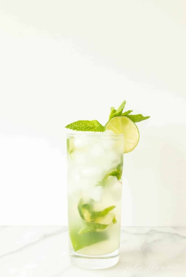 vodka mojito in a mojito glass garnished with lime slice and mint sprig