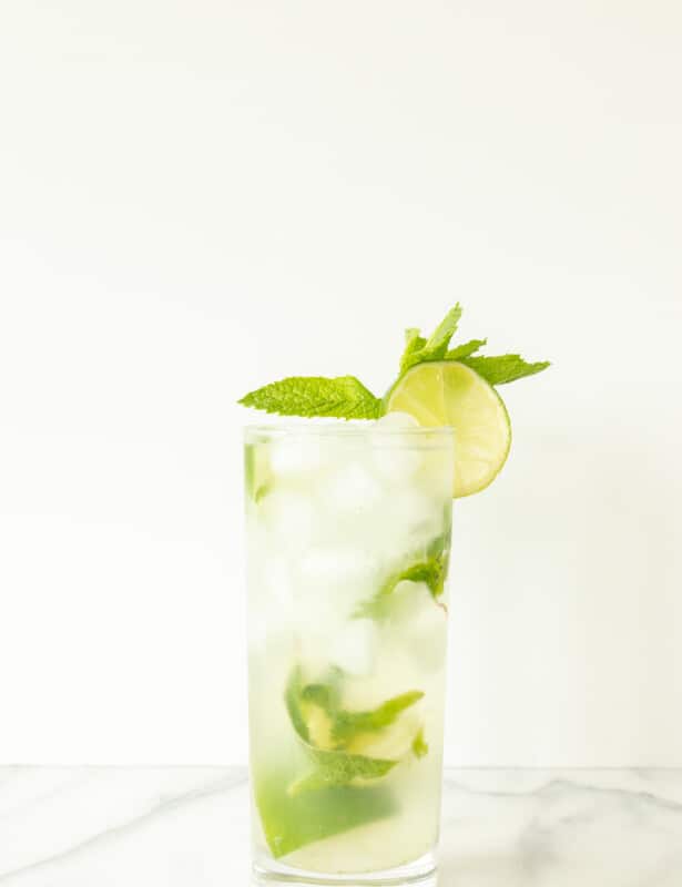 vodka mojito in a mojito glass garnished with lime slice and mint sprig