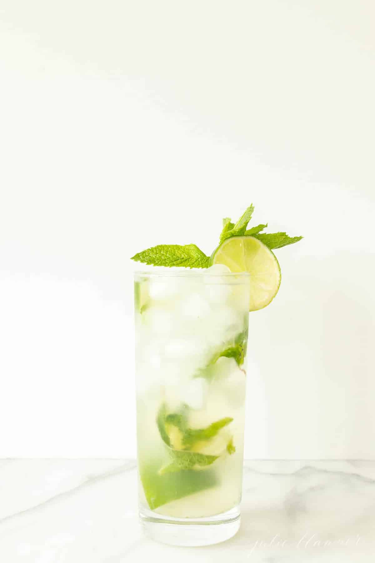 vodka mojito in a mojito glass garnished with lime slice and mint sprig