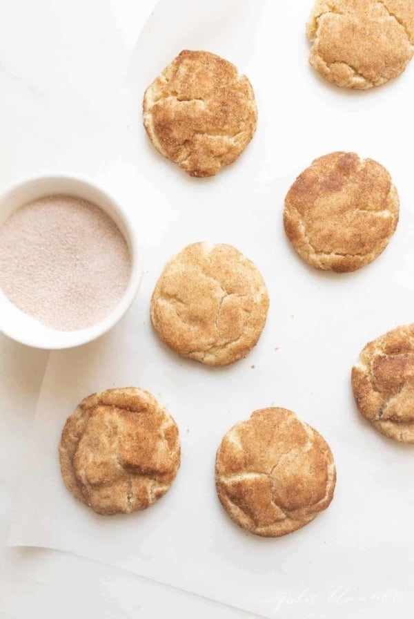 Soft and fluffy snickerdoodle cookies on a white countertop. #easysnickerdoodlecookierecipe #softsnickerdoodlerecipe