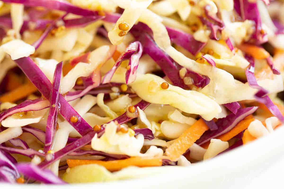 close up of cabbage salad with vibrant coleslaw and Dijon vinaigrette dressing. #cabbagesalad