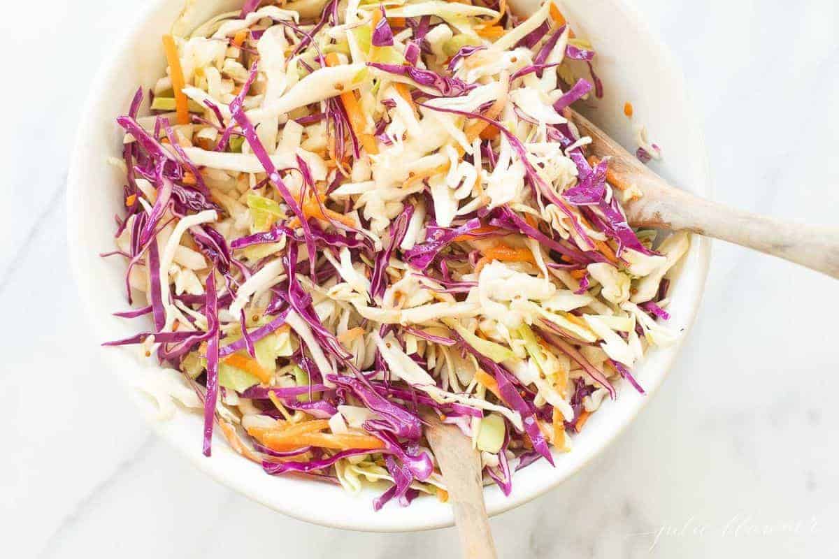 Colorful cabbage salad in a white bowl. 