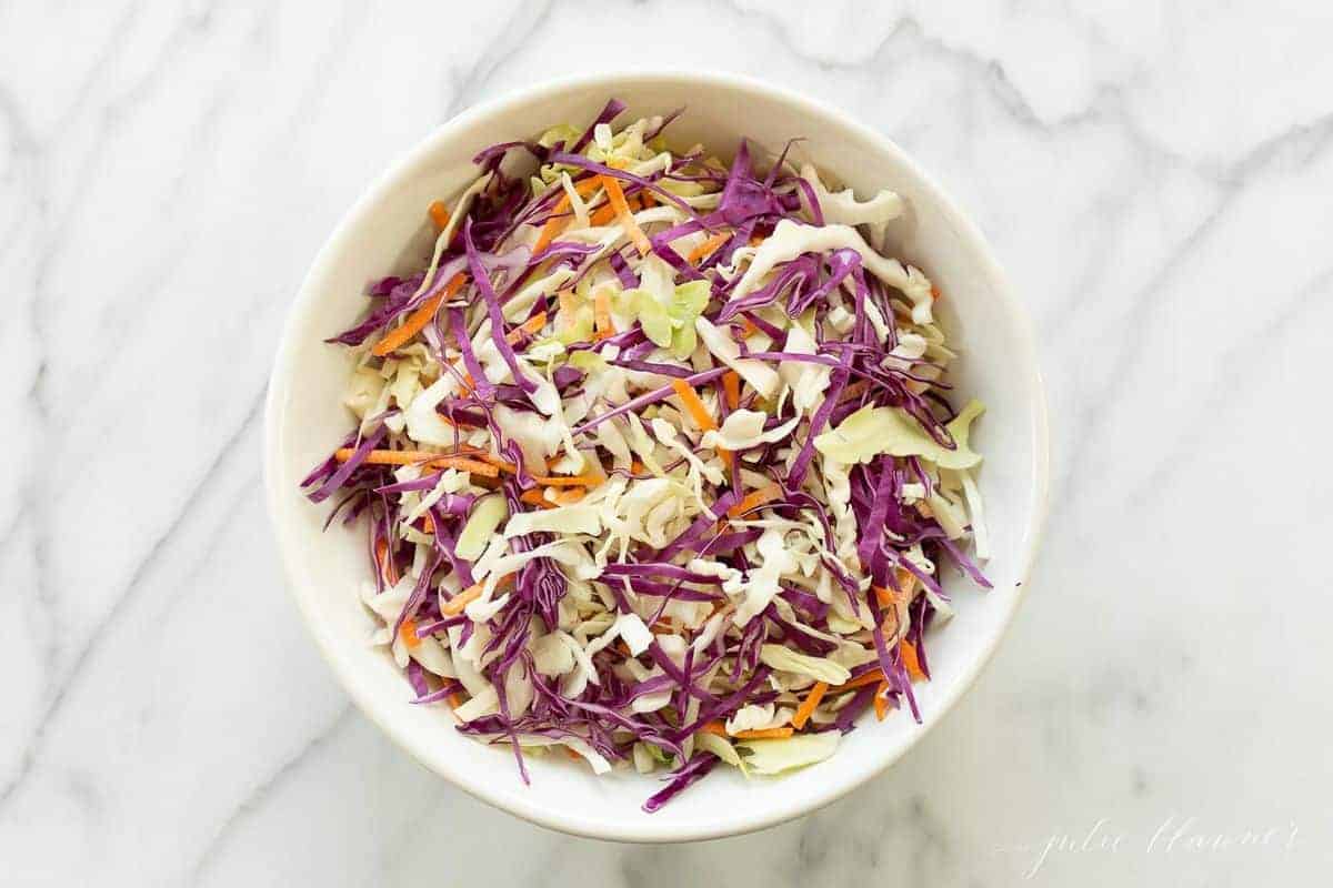 Colorful cabbage salad in a white bowl. 