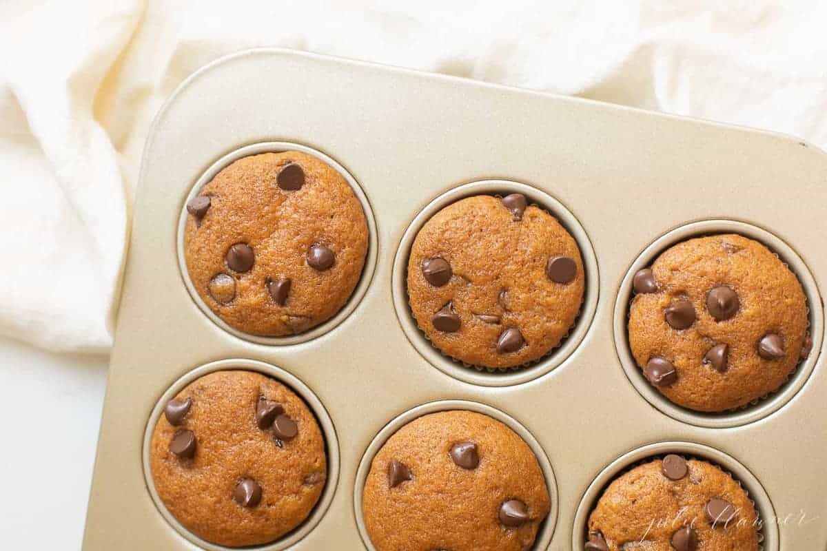 pumpkin chocolate chip muffins in muffin pan
