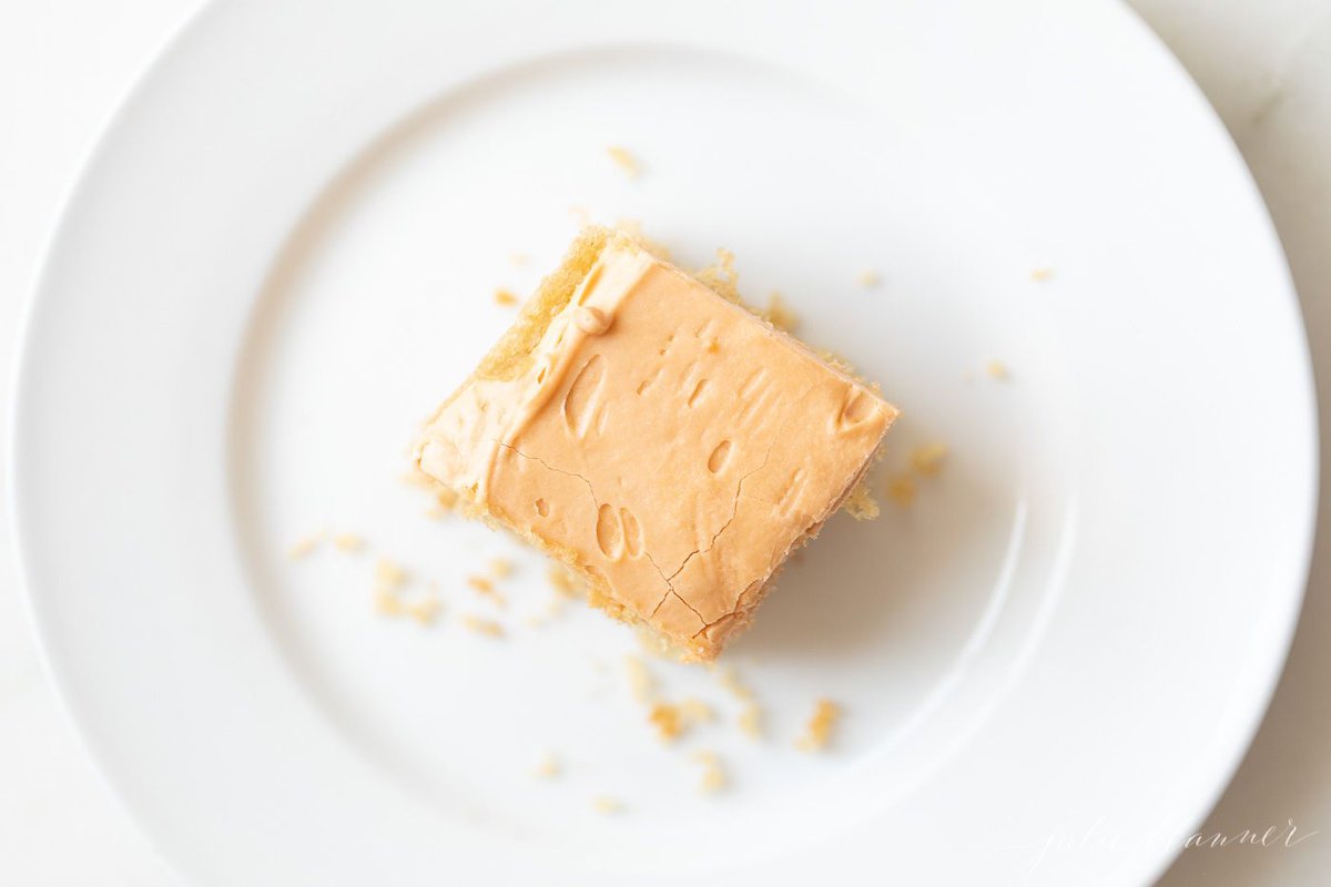 A slice of butterscotch cake on a white plate.