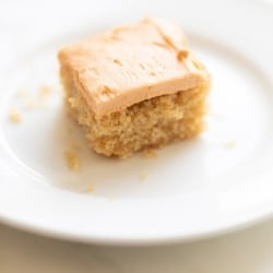 A slice of butterscotch cake on a white plate.