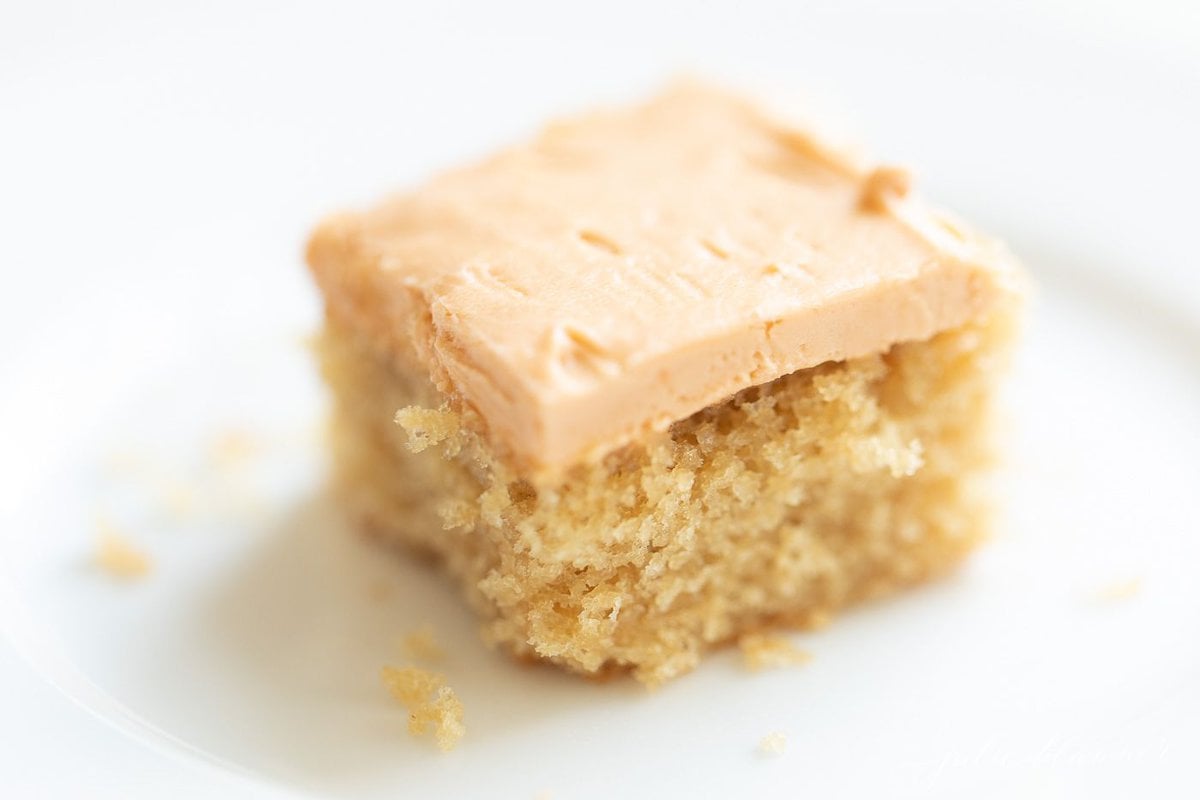 A slice of butterscotch cake on a white plate.