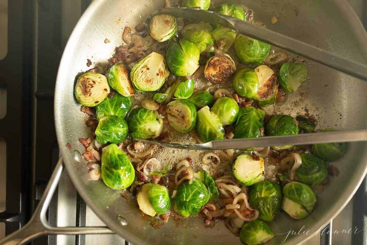 Aluminum pan on the stovetop, fresh pancetta shallots and brussel sprouts cooking down.