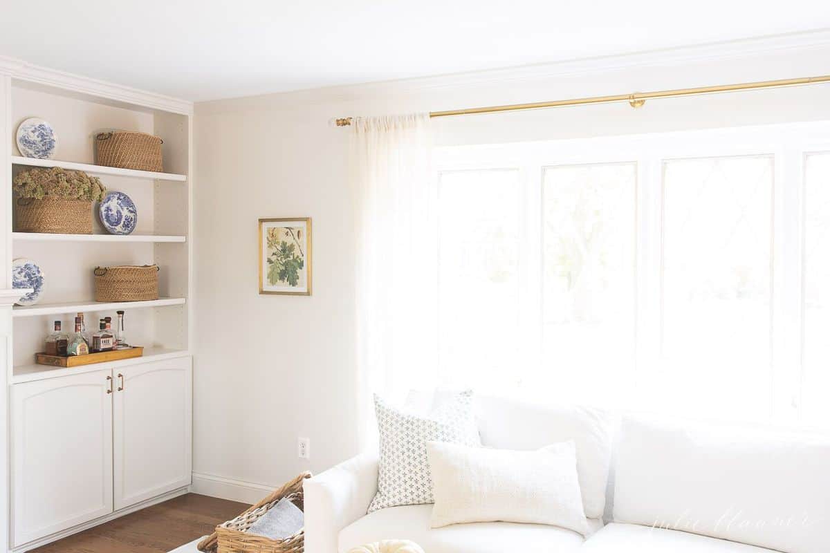 White sofa in living room in front of large window. 