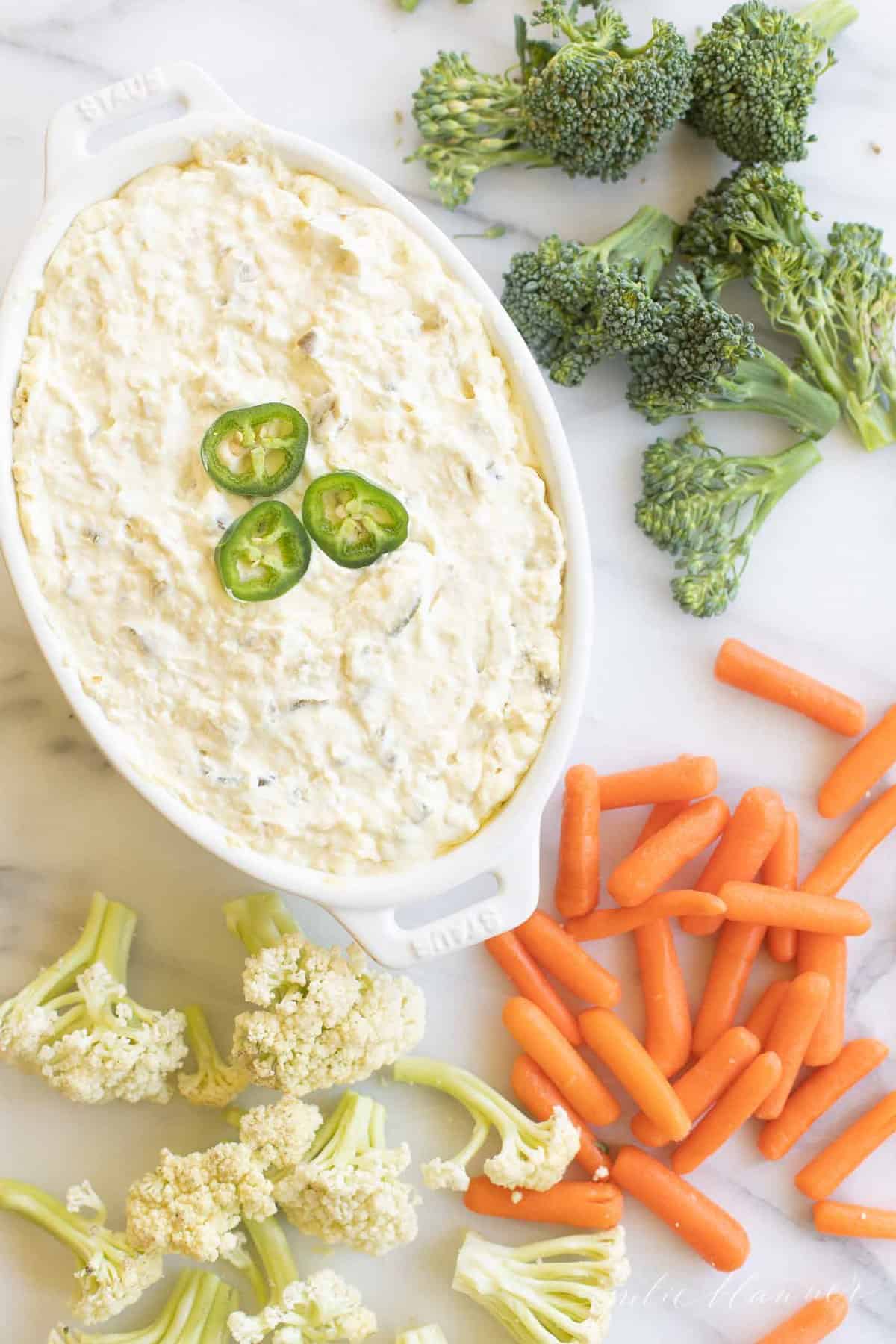 jalapeno dip surrounded by cauliflower carrots and broccoli