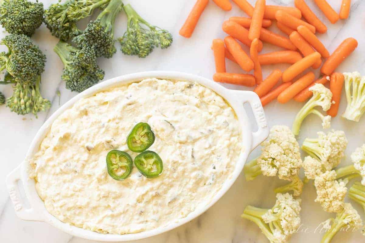 jalapeno cheese dip in casserole dip surrounded by veggies