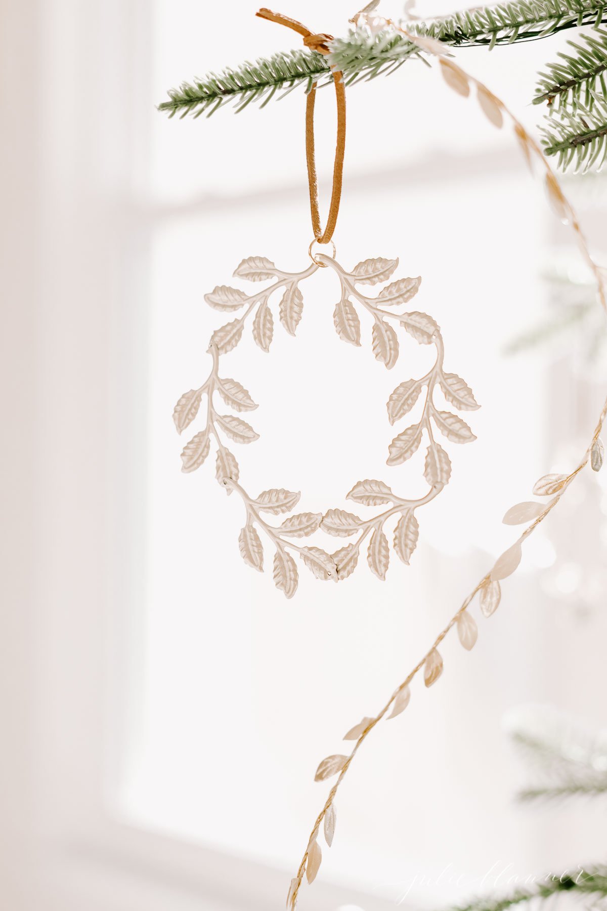 A laurel wreath ornament hanging from a tree.