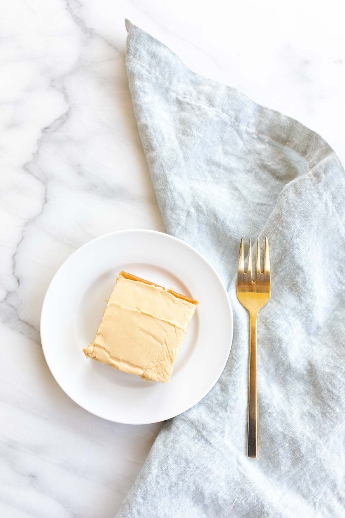 A slice of peanut butter cake on a white plate.