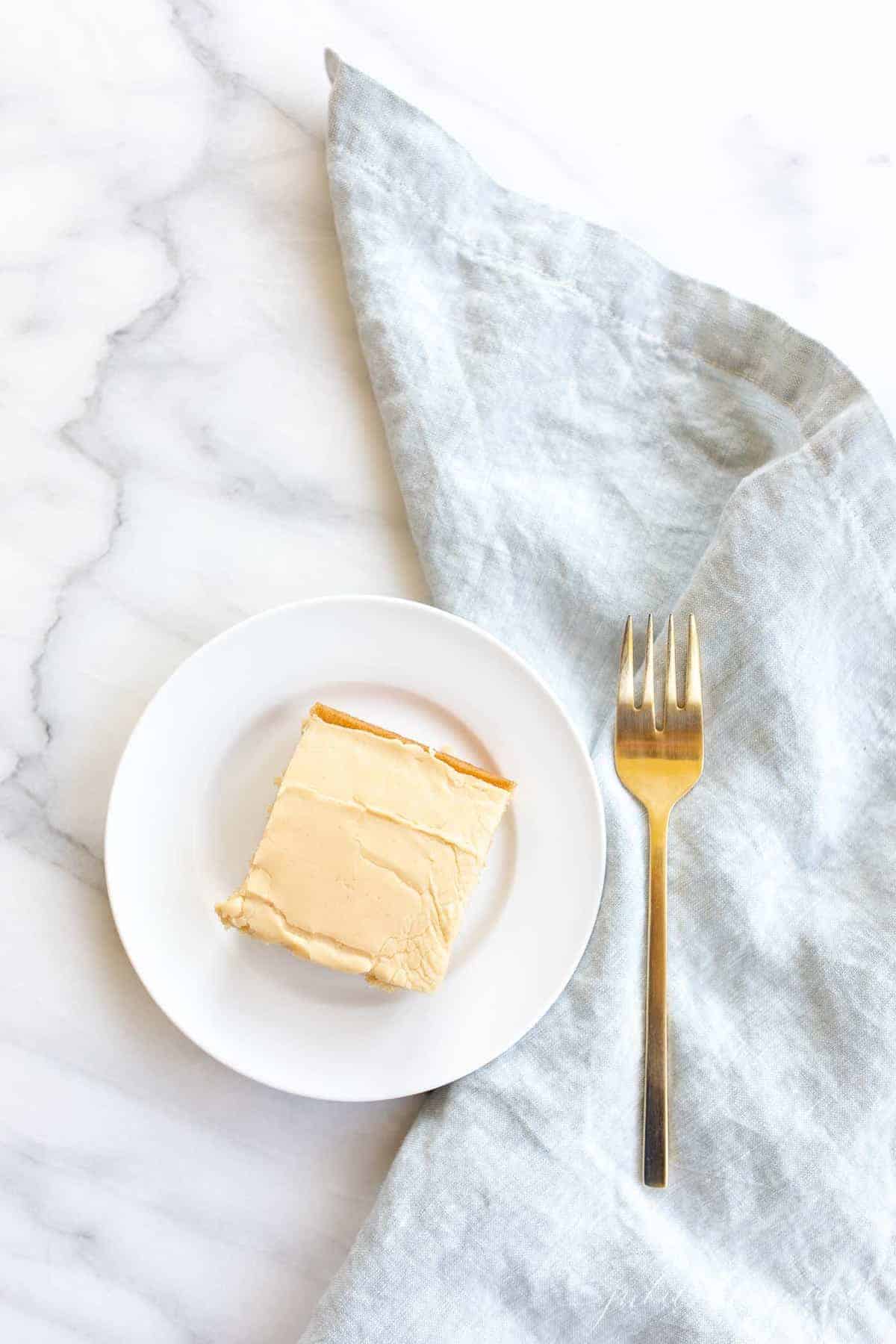 peanut butter cake and icing with napkin and fork