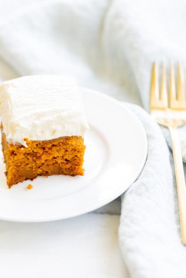 A Pumpkin cake with frosting on a plate.