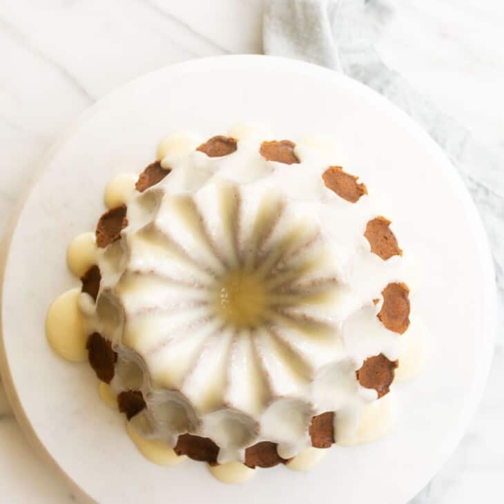 Down shot looking into a pretty bundt cake covered in cream cheese glaze.