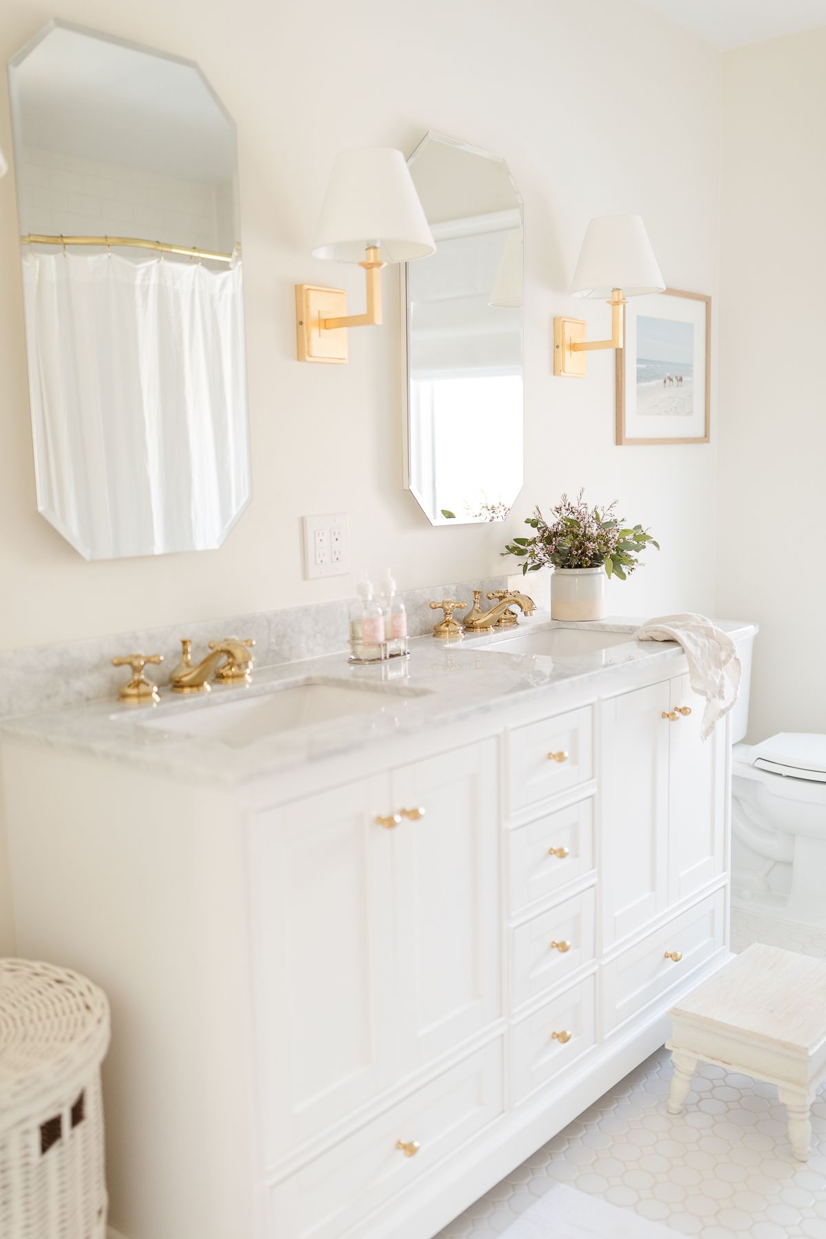 A spa bath with a white vanity and gold fixtures