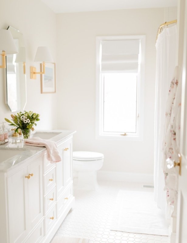 A spa bath with a white vanity and gold fixtures
