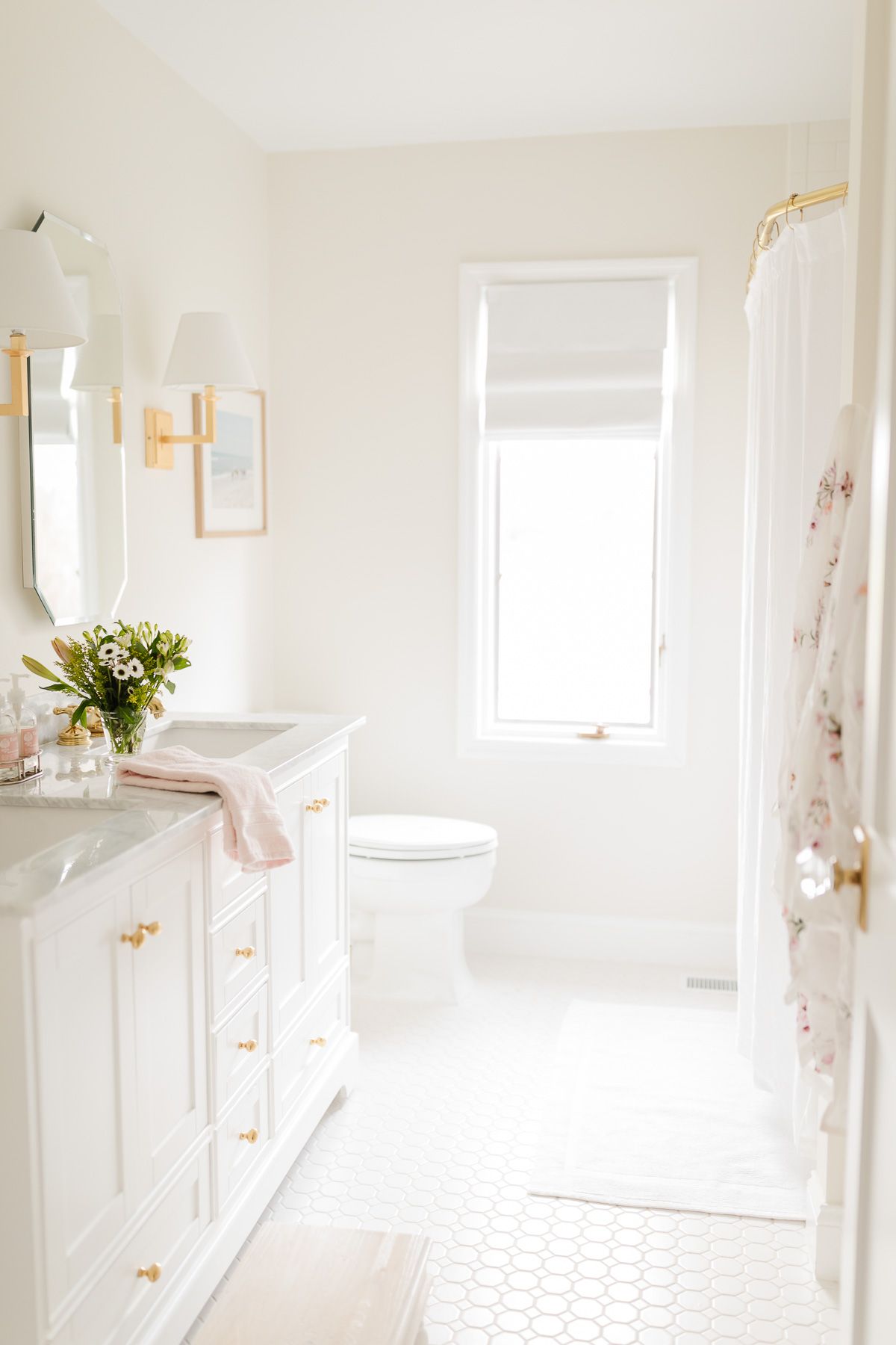 A spa bath with a white vanity and gold fixtures