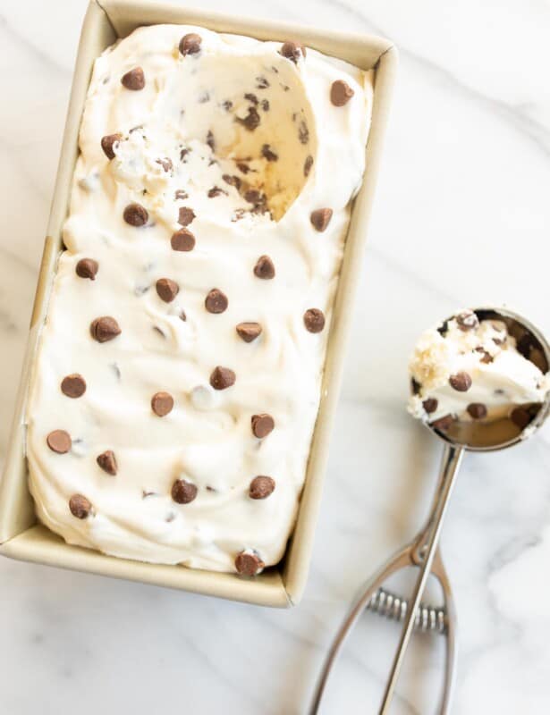 Chocolate chip ice cream in a loaf pan and an ice cream scoop