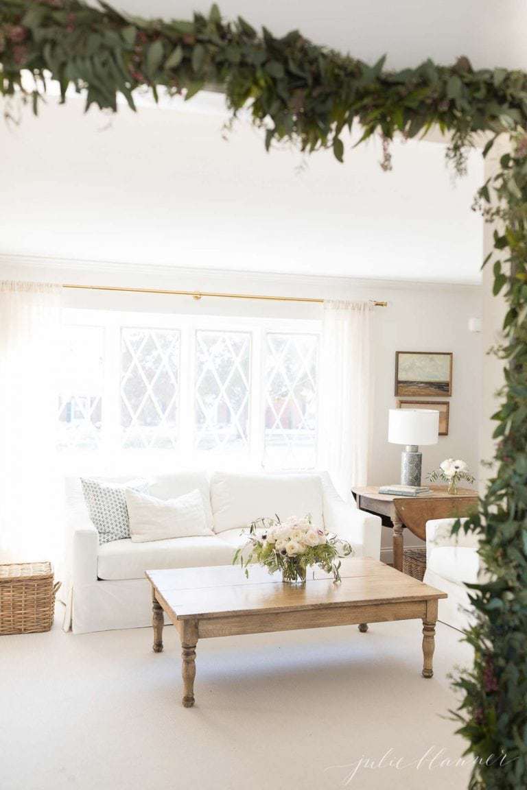 A white living room decorated for the holidays with easy Christmas decorations.