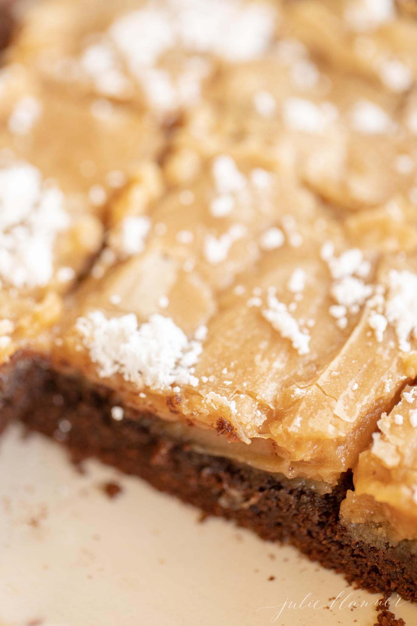 Peanut butter ooey gooey butter cake, sliced with pieces missing.