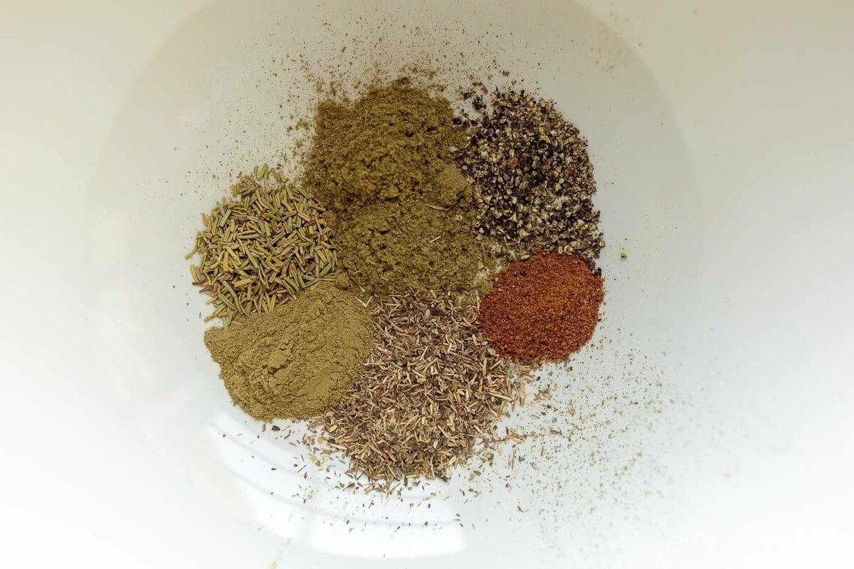 Spices on a white plate to make a chicken seasoning recipe blend