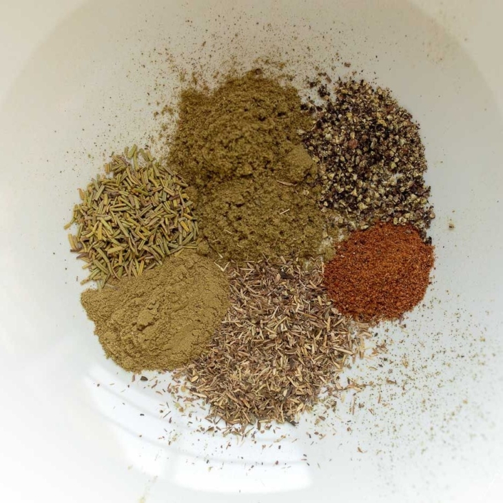 Spices on a white plate to make a chicken seasoning recipe blend