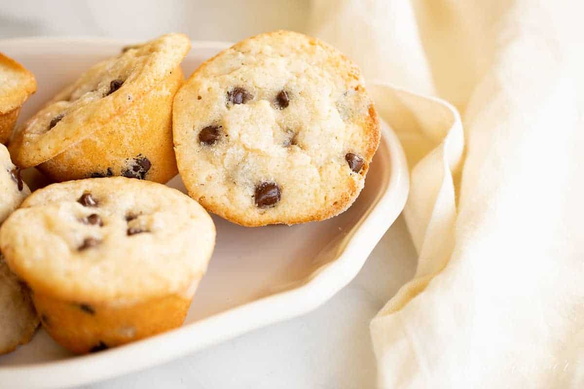 chocolate chip muffins in a serving dish with linen napkin