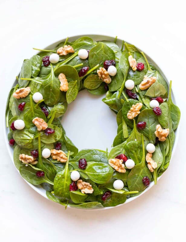 christmas salad in shape of a wreath with goat cheese cranberries and nuts to look like berries