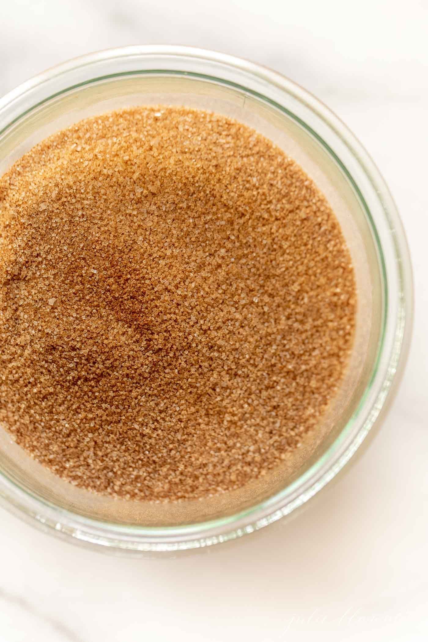 A small glass jar full of a homemade cinnamon sugar recipe.