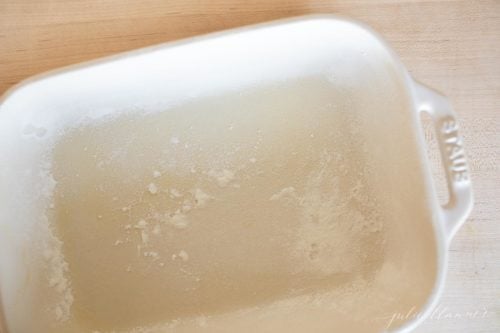 Looking into a white baking dish with flour sprinkled inside.