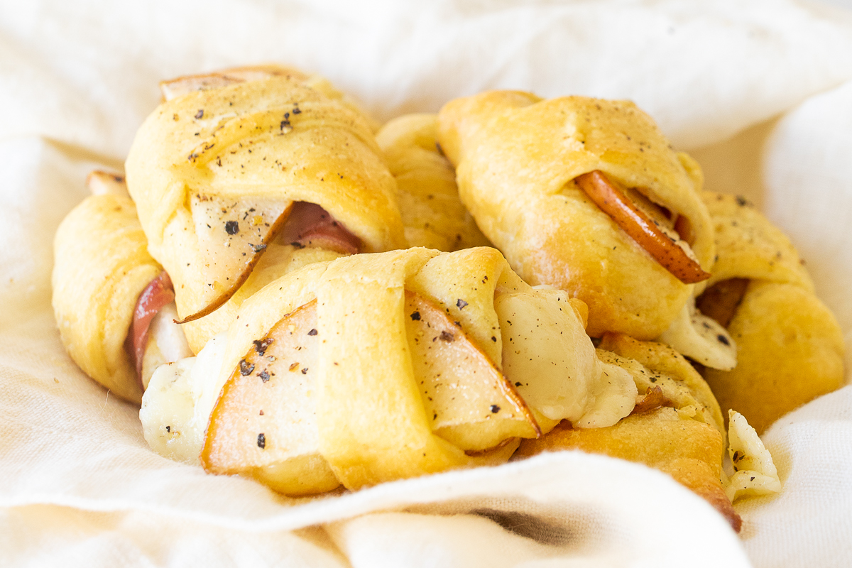 A bowl of apple and cheese wrapped in a napkin, served as delightful Crescent Roll Appetizers.