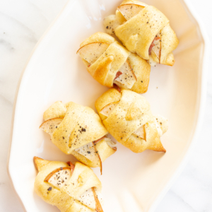 A white plate with a selection of Crescent Roll Appetizers on it.