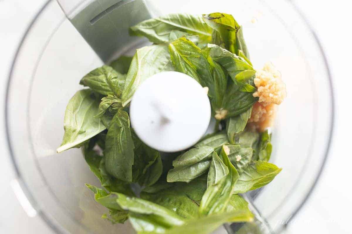 Looking inside a food processor, making pesto aioli.