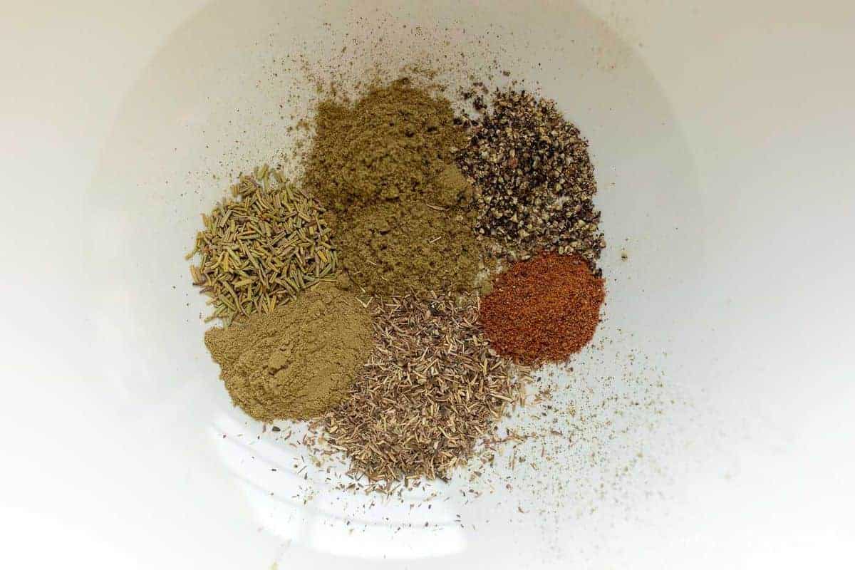 Inside of white bowl, mix of herbs and spices.
