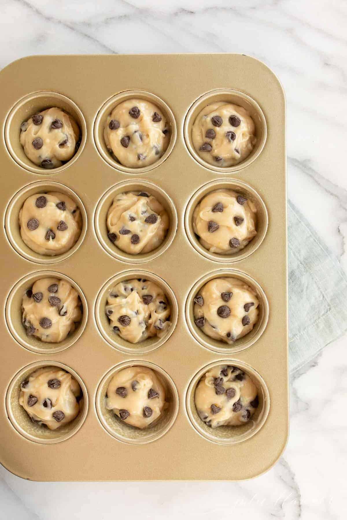 chocolate chip cookie muffin batter in muffin tin