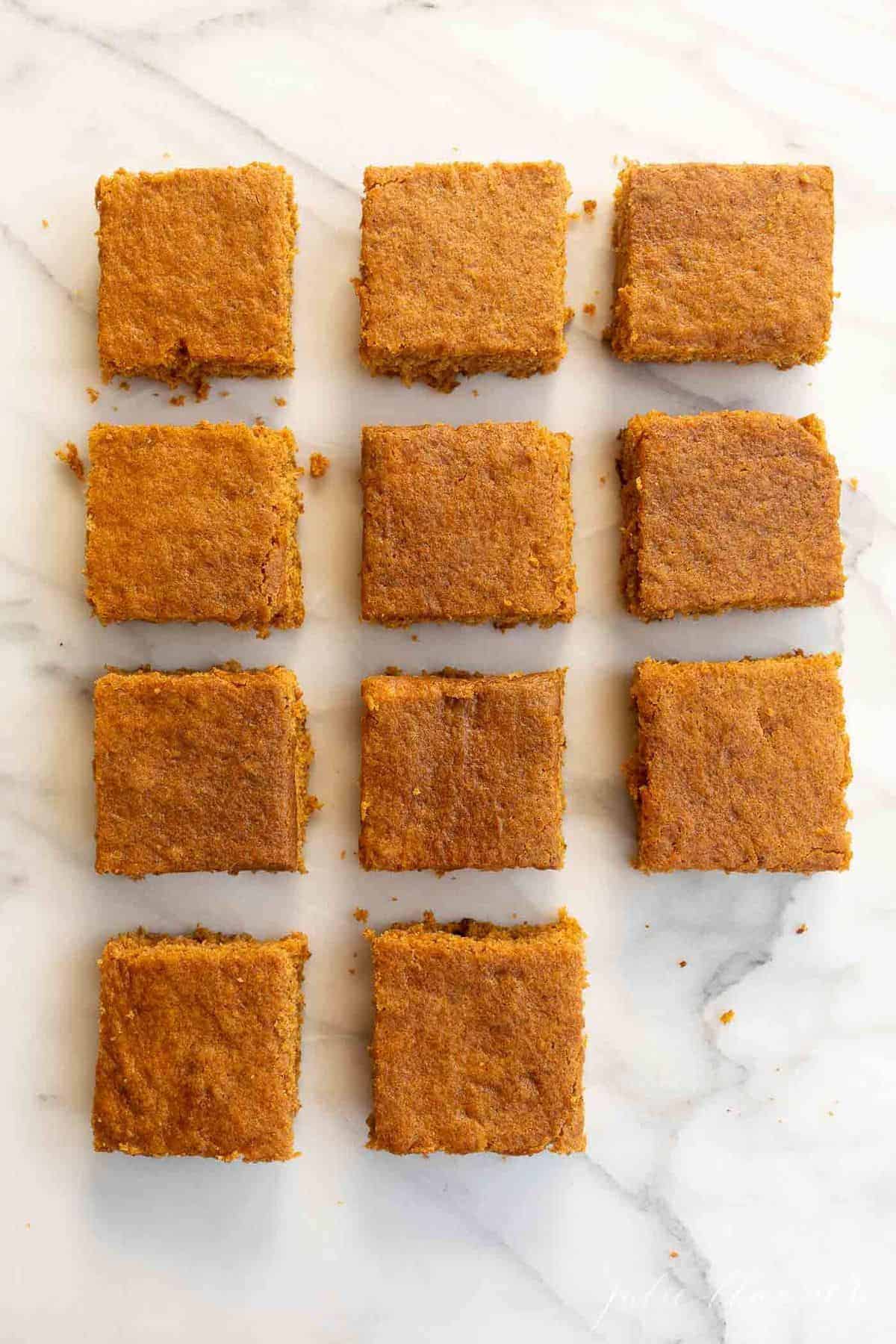 Marble surface with cut pumpkin bars placed neatly together.