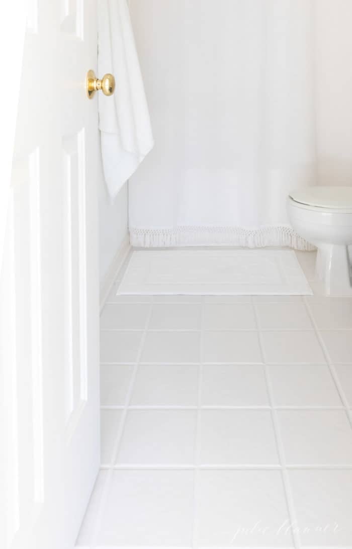 WHITE BATHROOM WITH WHITE TILE AND TILE GROUT