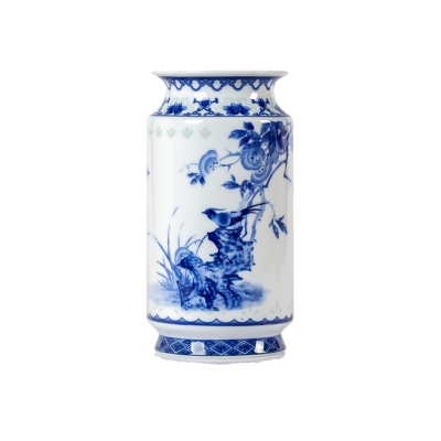 A blue and white vase with a bird on it, perfect for holiday homes.