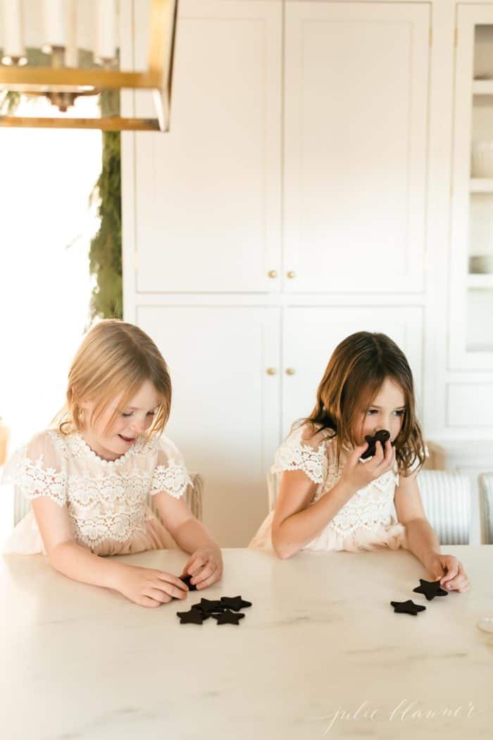 Two little girls working on a christmas gift experience