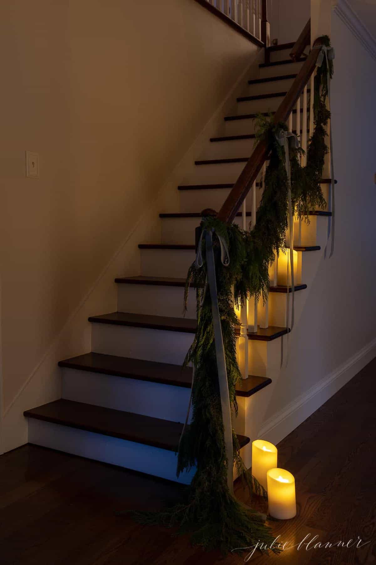 stairs lined in candles and garland for christmas