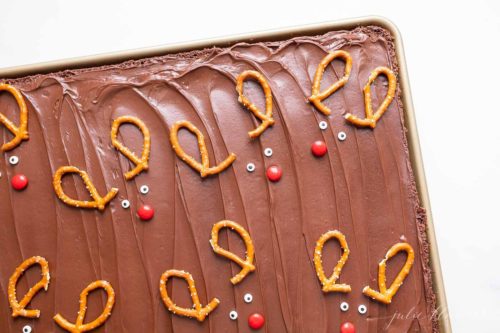 A pan of Christmas brownies decorated with reindeer pretzel antlers.