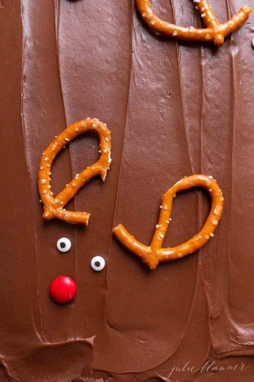 Reindeer brownies decorated with pretzel antlers and red noses.