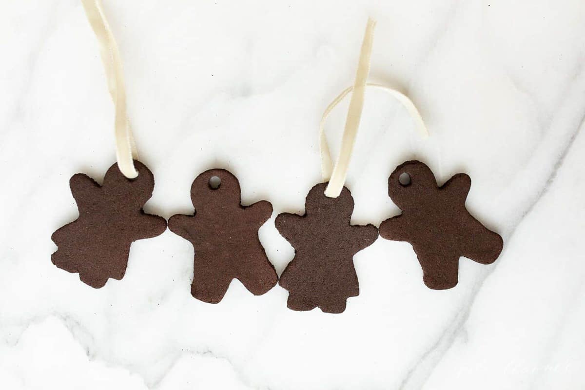 Marble surface, four gingerbread cinnamon ornaments.