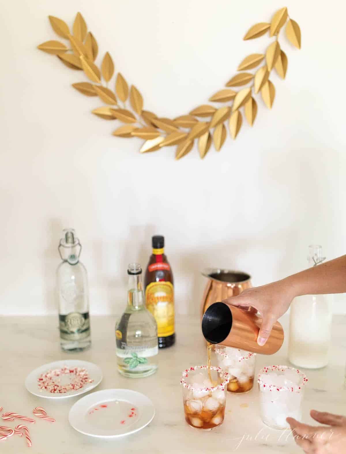 A white counter in a kitchen bar, ingredients for peppermint white russians.