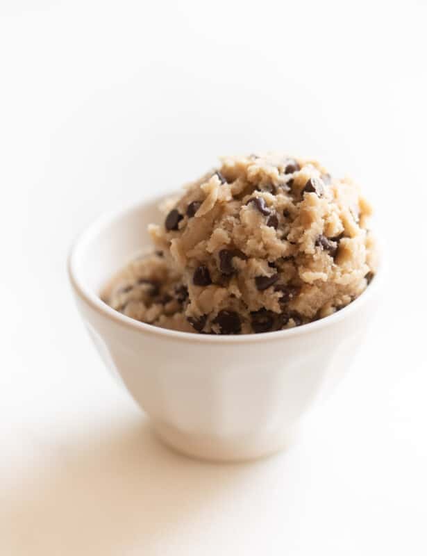Two scoops of edible cookie dough in a white bowl