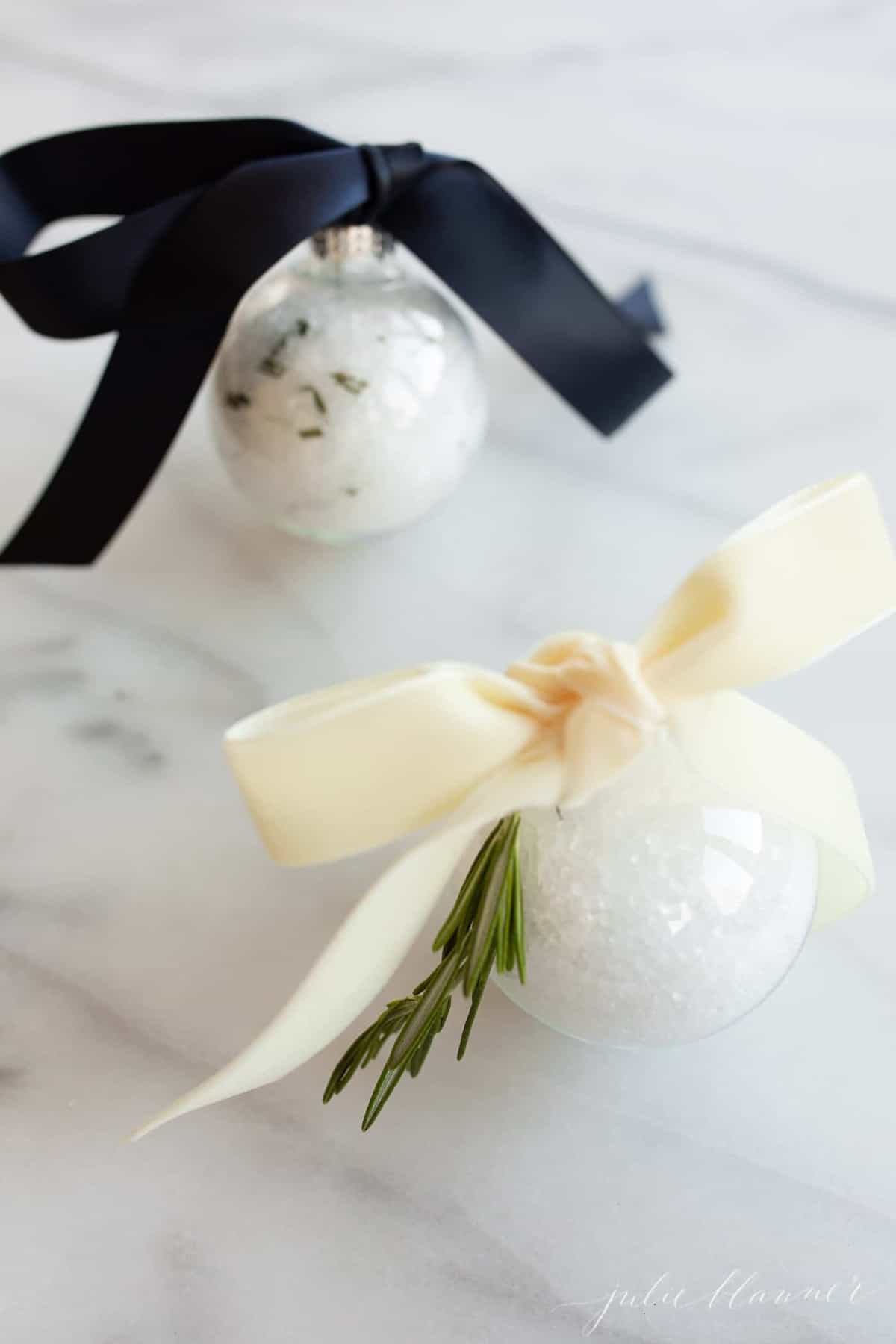 bath soak inside plastic ornaments tied with ribbon