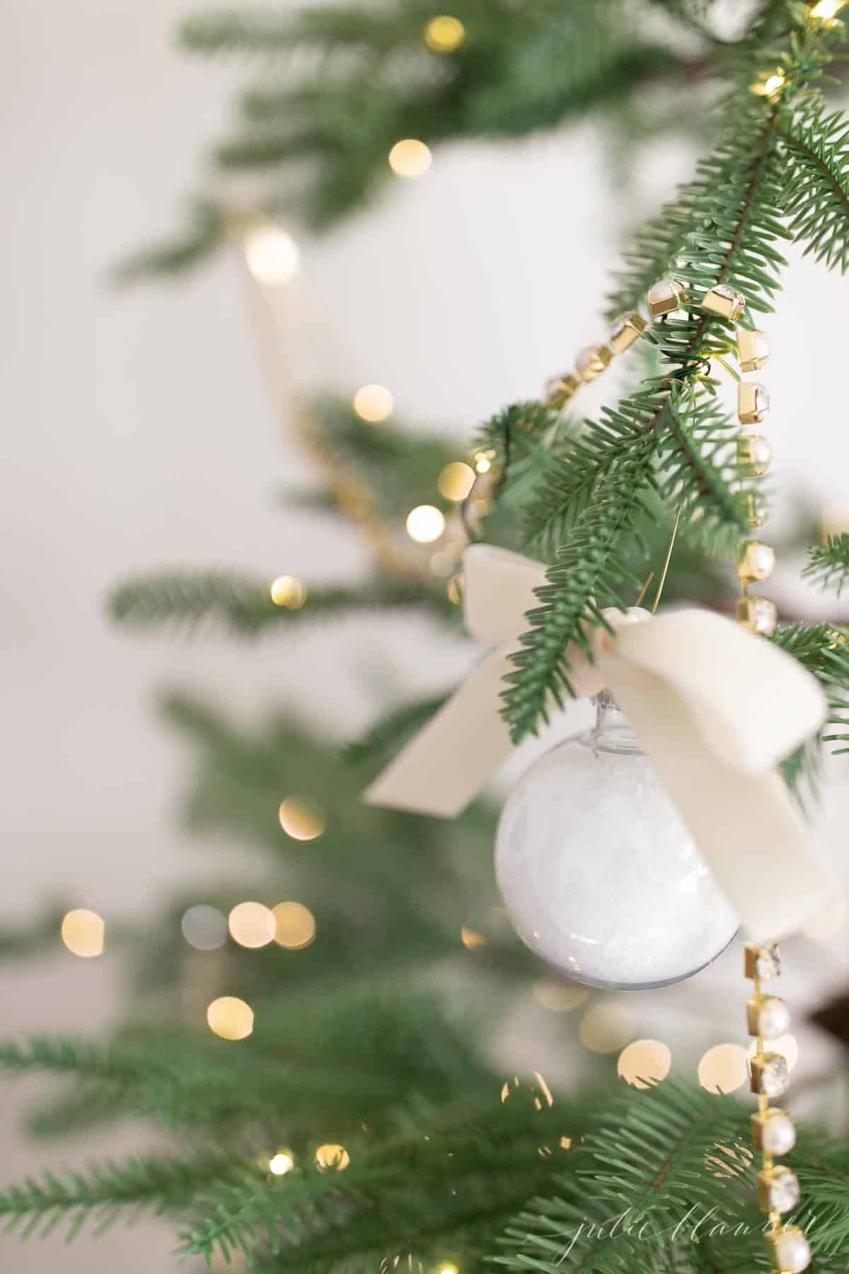 bath salt ornament hanging on tree with lights