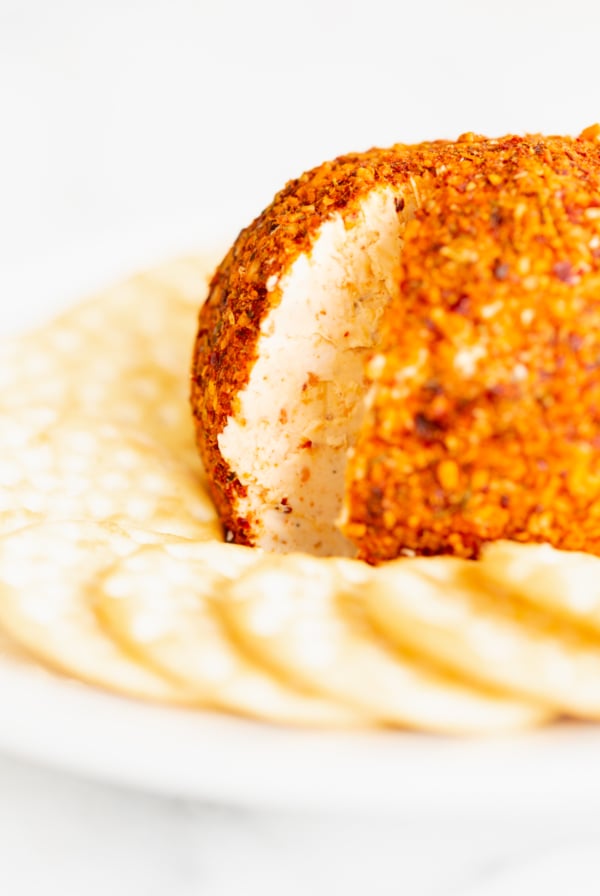 A cheese ball recipes showcase with crackers on a plate.